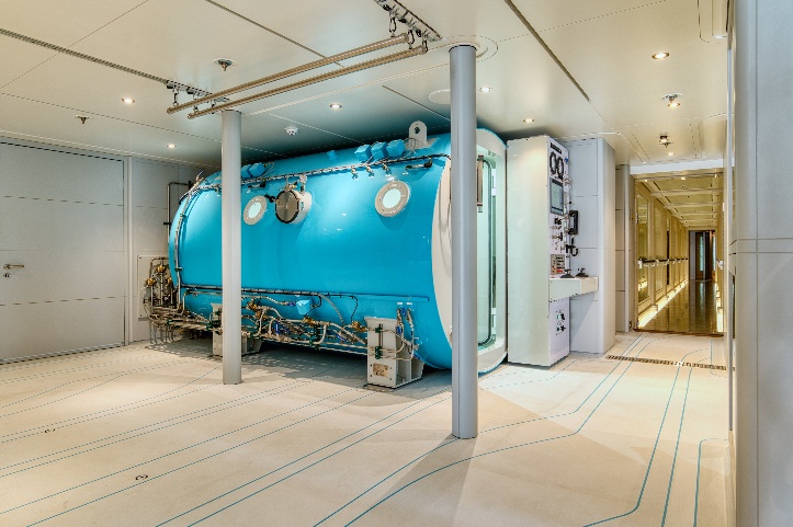 Side view of the custom turquoise chamber integrated beneath the yacht’s ceiling services